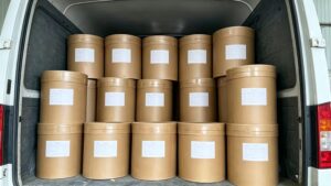 Bulk paper drum packaging of Chromium Glycinate raw material in warehouse, ready for global export shipment
